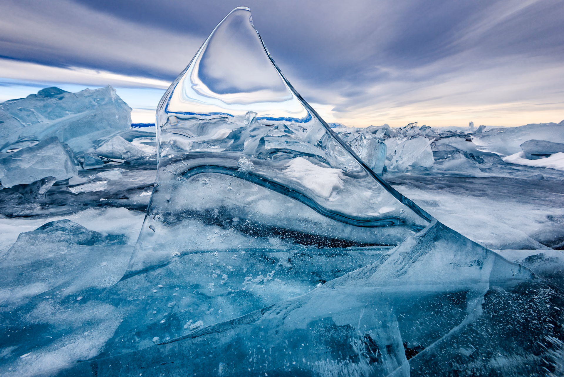 A thin clear slab of ice standing like a sail among the hummocks of Lake Baikal